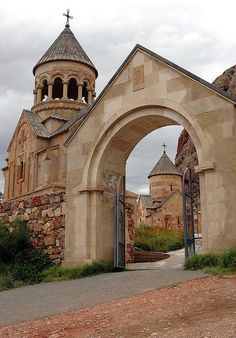 an old church with a stone archway and steeple