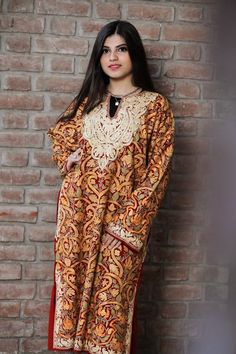 A stunningly marvellous Pheran. This Pheran features intricate Kashmir Aari embroidery on all-over the front side and on the sleeves.- - - - - - - - - - - - - - - - - - - - Product Details- Condition: Brand New (made to order)- Style: Phiran Tunic- Fabric: Pure Wool- Colour: Red- Embroidery: Jaal Aari Work- Embroidery Colour: Multi-Colour- Standard Length: 40" | Can be customized- Care Instructions: Dry Clean Only.**If you want the Tunic to be shorter or longer, just send us a message, and we wi Traditional Multicolor Kaftan For Wedding, Traditional Long Sleeve Kaftan For Navratri, Traditional Gold Kaftan For Festivals, Semi-stitched Dabka Kaftan For Festivals, Embroidered Bollywood Style Semi-stitched Kaftan, Multicolor Embroidered Kaftan With Zari Work For Festive Season, Festive Embroidered Kaftan With Zari Work, Festive Multicolor Embroidered Kaftan With Zari Work, Bollywood Style Multicolor Embroidered Kaftan For Eid