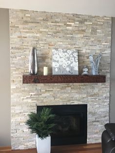 a living room with a fire place and a vase on the mantel above it