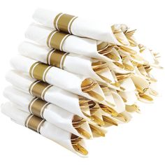 a stack of white and gold napkins on top of each other in front of a white background