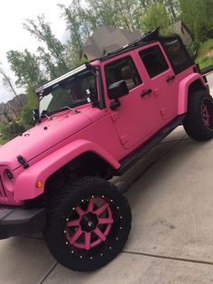 a pink jeep parked in front of a house