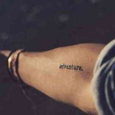 a woman's arm with the words adventures written on it