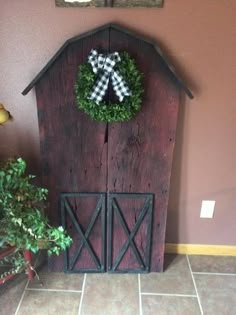 a wooden barn with a wreath on the door