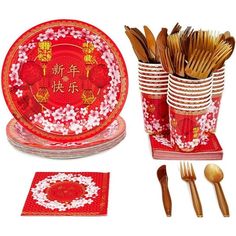 a set of red and white dinnerware with chinese writing on the plates, napkins, forks, spoons and utensils