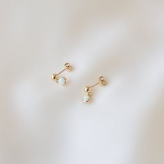 A pair of dainty gold earrings featuring an opal dangle. Opals are 3mm in diameter, are synthetic, and waterproof. Earring posts are 14K gold filled. These earrings are water-resistant, tarnish-resistant, and hypoallergenic. --------------------♥ PROMOS ♥-------------------- Want 10% off? Join the mailing list by visiting http://bit.ly/vedern . Just leave me a note at checkout if you have any problems applying discount codes. --------------------♥ BUY WITH CONFIDENCE ♥-------------------- Don't Simple Earrings Gold, Small Gold Earrings, Opal Jewelry Earrings, Opal Jewellery, Earring Inspo, Simple Gold Earrings, Piercing Inspo, Dainty Gold Earrings, 2024 Wishlist