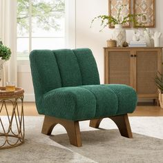 a living room with a green chair in the middle and a rug on the floor