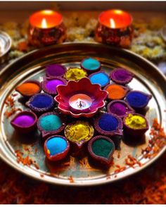 colorful diya with candles on a metal tray