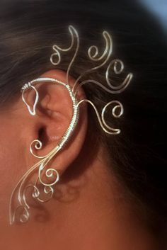 a close up of a woman's ear with an intricate design on it