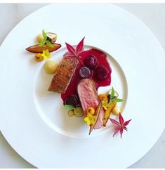 a white plate topped with different types of food and garnishes on top of it