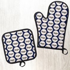 two oven mitts with logos on them sitting next to each other in front of a white background