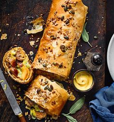 a loaf of bread sitting on top of a wooden cutting board next to a knife