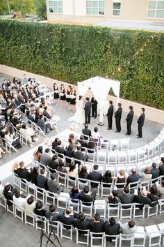 an overhead view of a wedding ceremony with white chairs