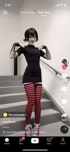 a woman in tights and stockings standing on stairs with her hands behind her head