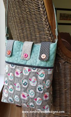 a purse sitting on top of a chair next to a wicker chair with buttons