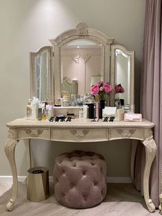 a dressing table with a stool and mirror