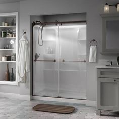 a bathroom with a walk in shower next to a sink