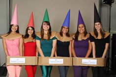 the women are wearing colorful hats and holding cardboard boxes