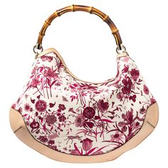 Gucci White/Pink Floral Canvas and Leather Peggy Bamboo Handle HoboHandbags as fabulous as this one are hard to come by. So own this gorgeous Gucci Peggy bag today and light up your closet Crafted from floral canvas and styled with leather trims this stunning number has a spacious canvas interior. It is held by a wonderfully created bamboo handle that makes the piece all the more worthy of being in your closet. Size: Height: 34.5 cm Width: 7 cm Length: 40 cmColour: WhiteMaterial: LeatherCondition: Excellent Floral Canvas, Bamboo Handles, Chic Me, Timeless Handbag, Hobo Handbags, Luxe Fashion, Bags Designer Fashion, Exclusive Bag, Leather Trims