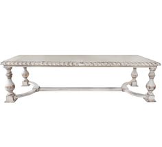 a white table with wooden legs and an ornate design on the top, against a white background