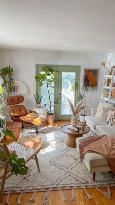 a living room filled with furniture and plants