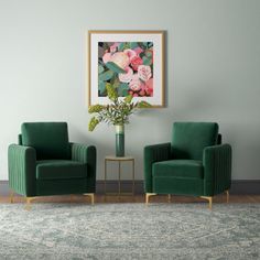 two green chairs sitting next to each other in front of a painting on the wall