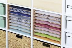 the drawers are filled with different types of fabric and baskets for storing items in them