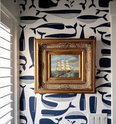 a painting hanging on the wall next to a radiator in a room with blue and white walls