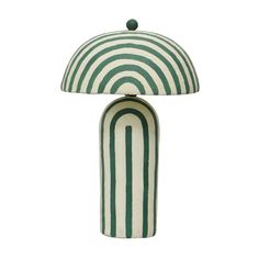 a green and white table lamp with a striped shade on the top, sitting in front of a white background