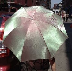 a person walking down the street with an umbrella