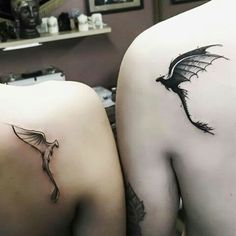 two people with tattoos on their backs, one has a dragon and the other has a bird