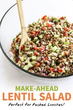 lentil salad in a glass bowl with a wooden spoon and title overlay reads make - ahead lentil salad perfect for packed lunches