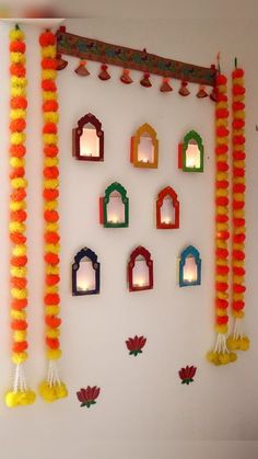 the wall is decorated with paper lanterns and candles for diwaling or decorating