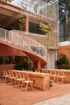 an outdoor seating area with wooden chairs and tables