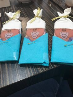 three folded blue towels with an image of a baby in a chef's hat on them