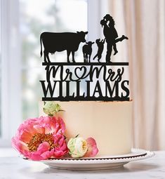 there is a cake that has been decorated with the silhouettes of people and animals