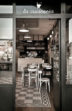 the inside of a restaurant with tables and chairs