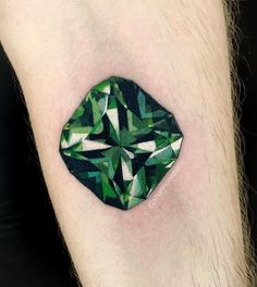 a green diamond tattoo on the leg