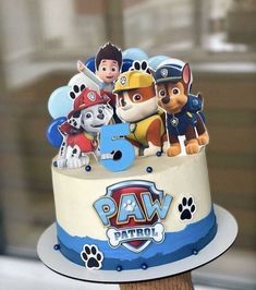 a birthday cake with paw patrol characters on it