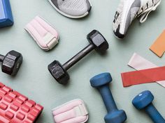 there are many different types of dumbs and exercise equipment on the floor with each other