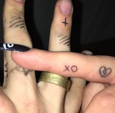 two fingers with tattoos on them and one has an eye drawn on the middle finger