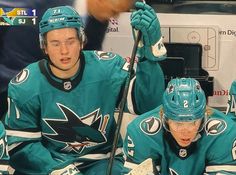 the hockey players are sitting on the bench