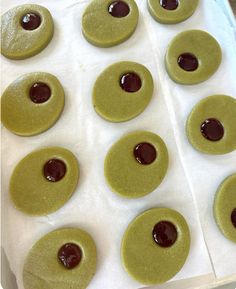 some green cookies with chocolate on them sitting in a pan and ready to go into the oven