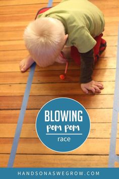 a toddler crawling on the floor with text overlay reading blowing pom pom race