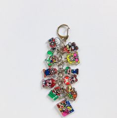 a key chain with mickey mouse charms attached to it's sides on a white surface