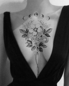 a woman's back with flowers and moon tattoos on her chest, in black and white