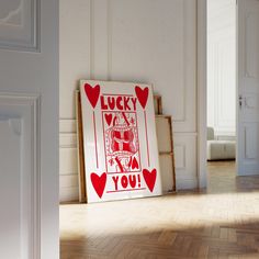 an image of a lucky card in the corner of a room with wood flooring