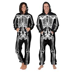 a man and woman wearing skeleton pajamas