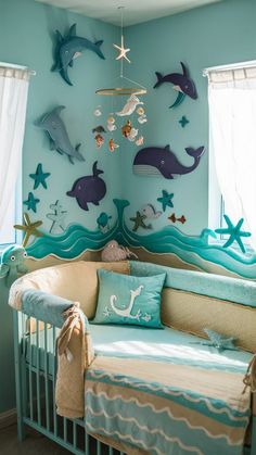 a baby's room decorated in blue and green with sea animals on the wall