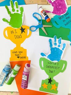 handprints and craft supplies are displayed on the table