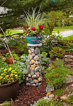 a garden filled with lots of different types of flowers and plants on top of rocks